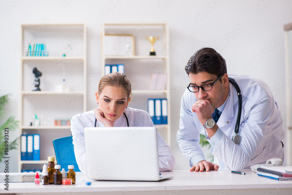 Male and female doctor having discussion in hospital Male and female doctor having discussion in hospital