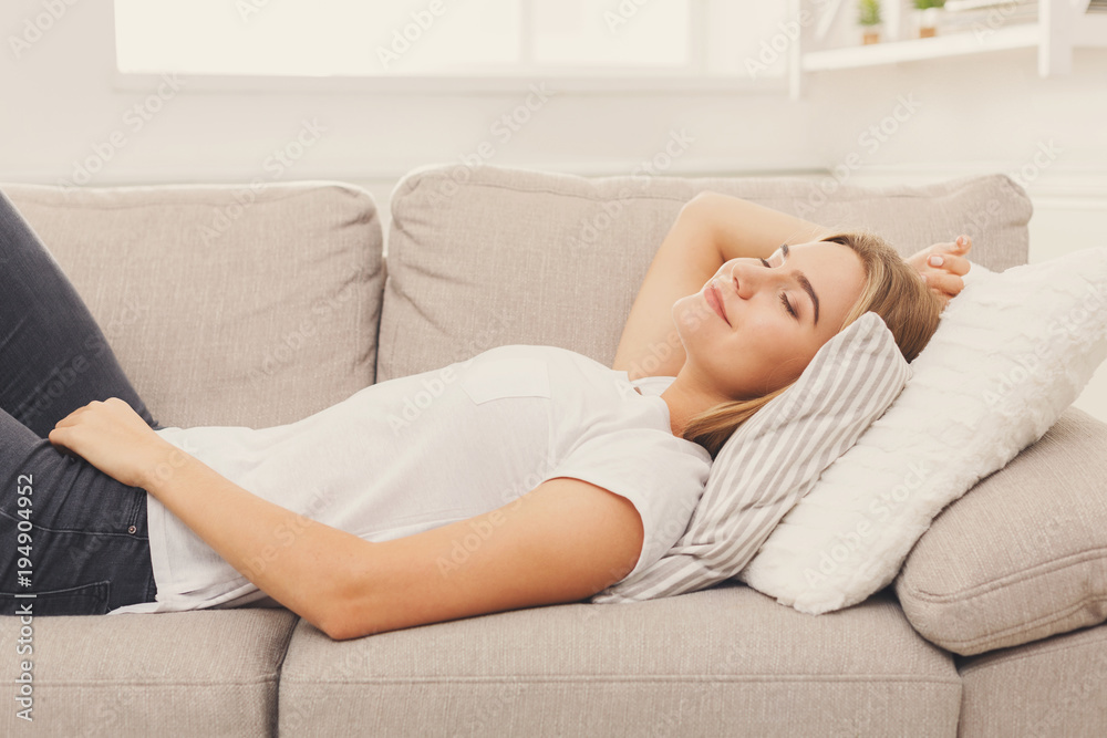 Happy young girl lying on sofa at home Happy young girl lying on sofa at home