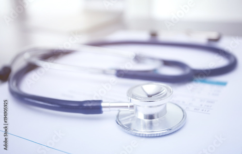 Medical equipment: blue stethoscope and tablet on white background. Medical equipment
