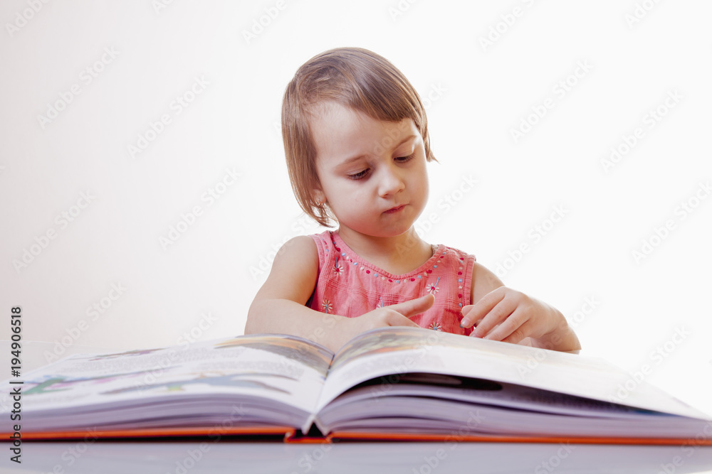 Girl child reading a book. (Education, knowledge, wisdom concept) Girl child reading a book. (Education, knowledge, wisdom concept)