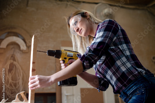 Woman drills wood