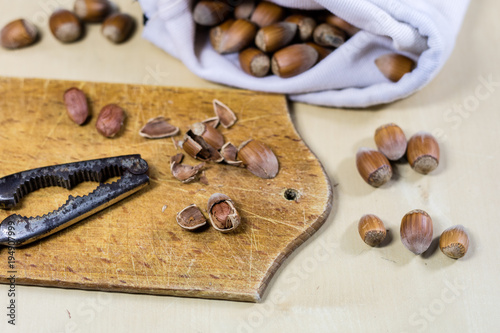 Tasty hazelnuts on a wooden kitchen table. Forest specialties and kitchen accessories.
