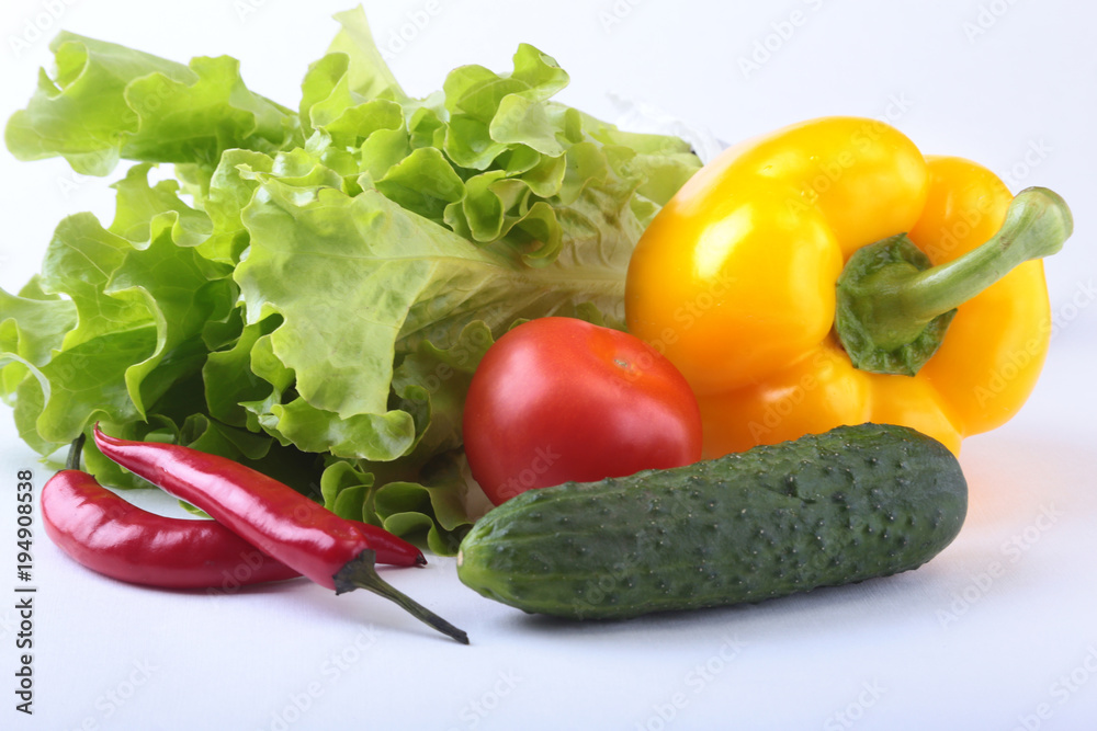 Assorted vegetables, fresh bell pepper, tomato, chilli pepper, cucumber and lettuce isolated on white background. Selective focus.