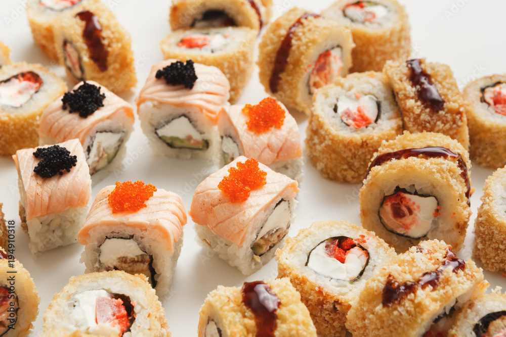 Closeup of sushi rolls on white background Closeup of sushi rolls on white background