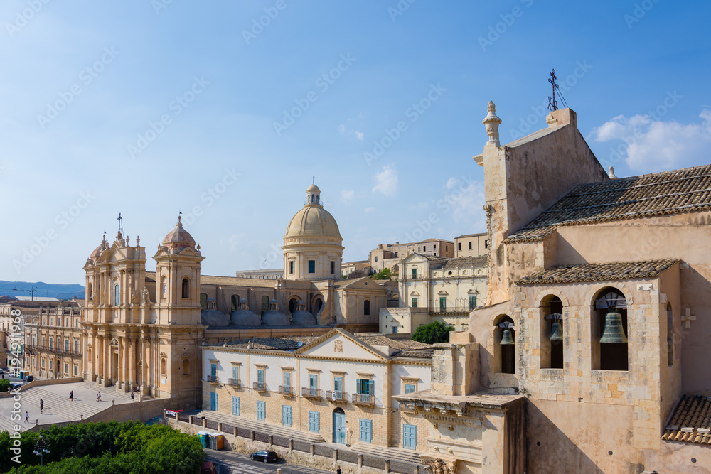 View of the baroque cathedral church, symbol of the city, you can also see the 3 bells of the Santissimo Salvatore church, Noto