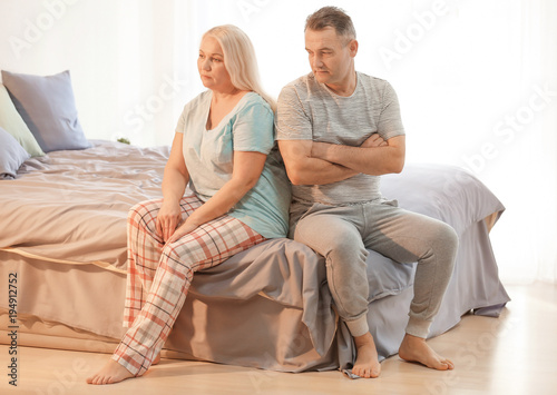 Obraz na plátně Senior couple with problem in relationship on bed