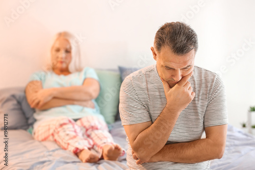 Plakat Senior couple with problem in relationship on bed