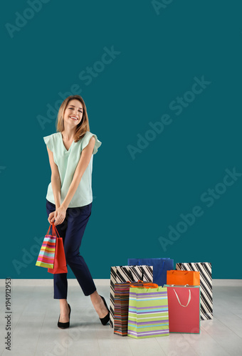 Happy young woman with shop...