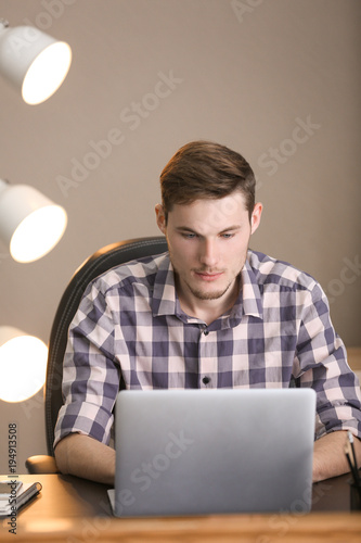 Young man working with lapt...