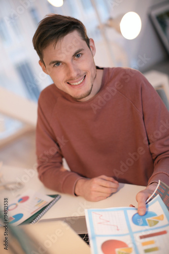 Young man working with docu...