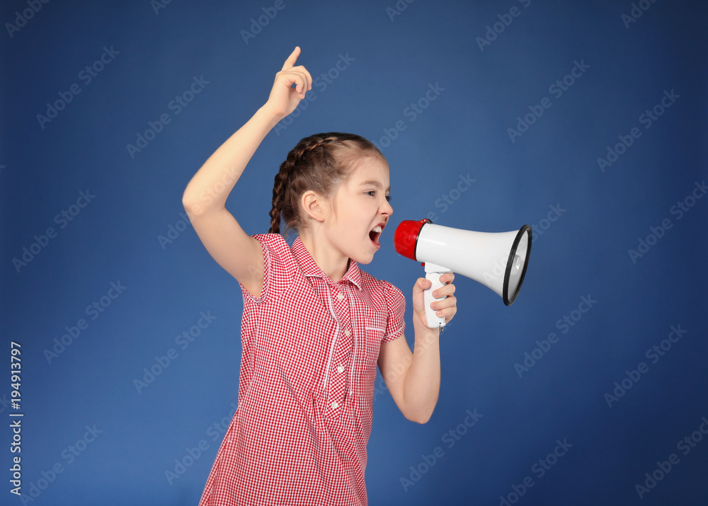 Emotional little girl shouting into megaphone on color background Emotional little girl shouting into megaphone on color background