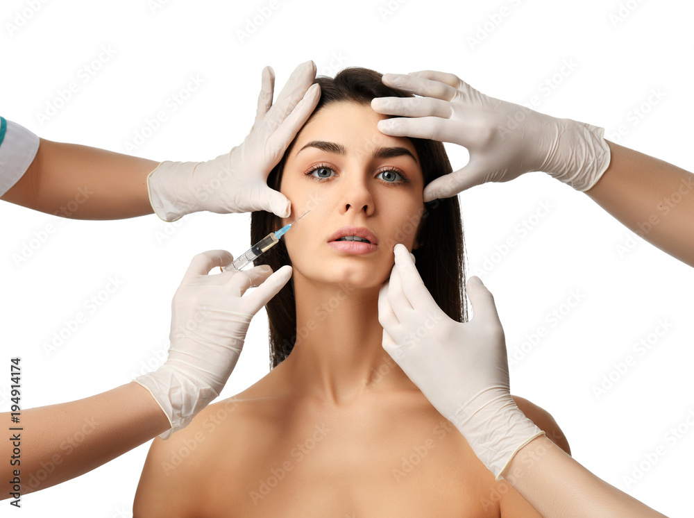 Naklejka premium Plastic surgery beauty concept young brunette woman face and doctor hand in glove with syringe