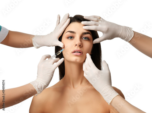 Plastic surgery beauty concept young brunette woman face and doctor hand in glove with syringe