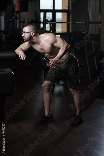 Geek Man With Dumbbell Exercising Triceps