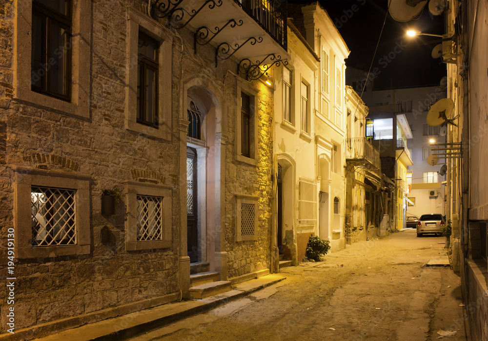 Night view of historical, old street in old town of Ayvalik. Sto
