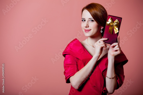 woman in red Victorian epoch clothes with gift box