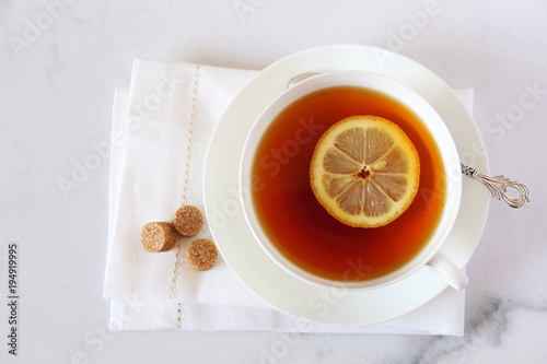 Black tea with lemon in a white bone china cup