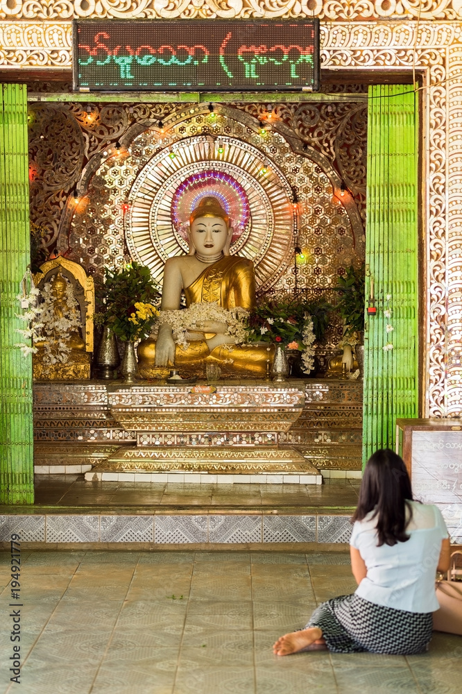 View of the golden statue of Buddha in Bagan, Myanmar. Vertical. Copy space for text.