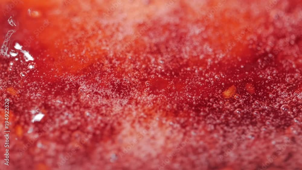 Close up of red cranberries boiling process in the boiler for jam. Macro shot. Close up of red cranberries boiling process in the boiler for jam. Macro shot.
