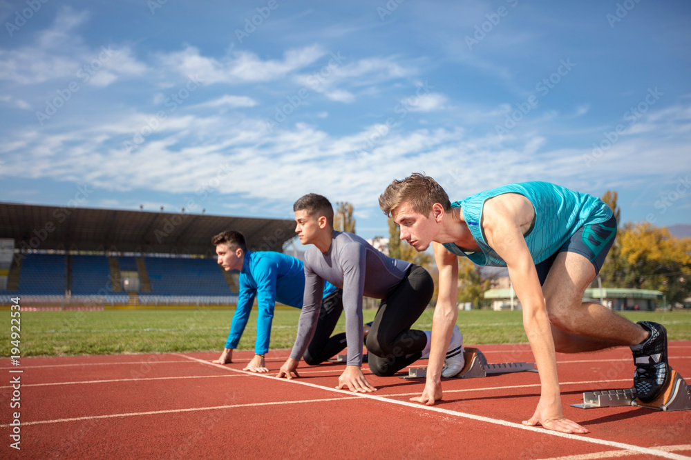 Athletes at the sprint start line in track and field