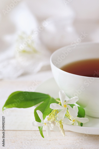 Jasmine tea in a white bone china cup on white background