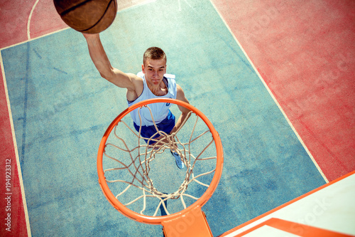 High angle view of basketball player dunking basketball in hoop © FS-Stock