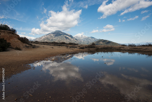 Water/Rain Puddle on Snowy Mount San Antonio (Mount Baldy) Under Cloudy Blue Sky in Winter in Southern California