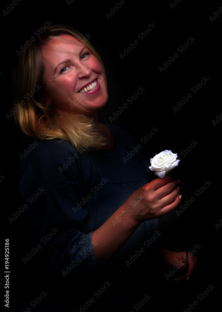 Portrait of a young woman with a white rose in her hand Portrait of a young woman with a white rose in her hand