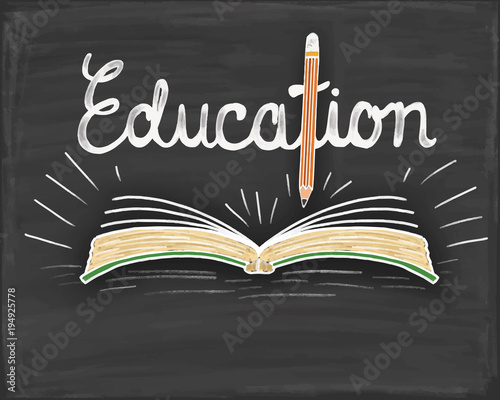 education text with book and pencil on blackboard