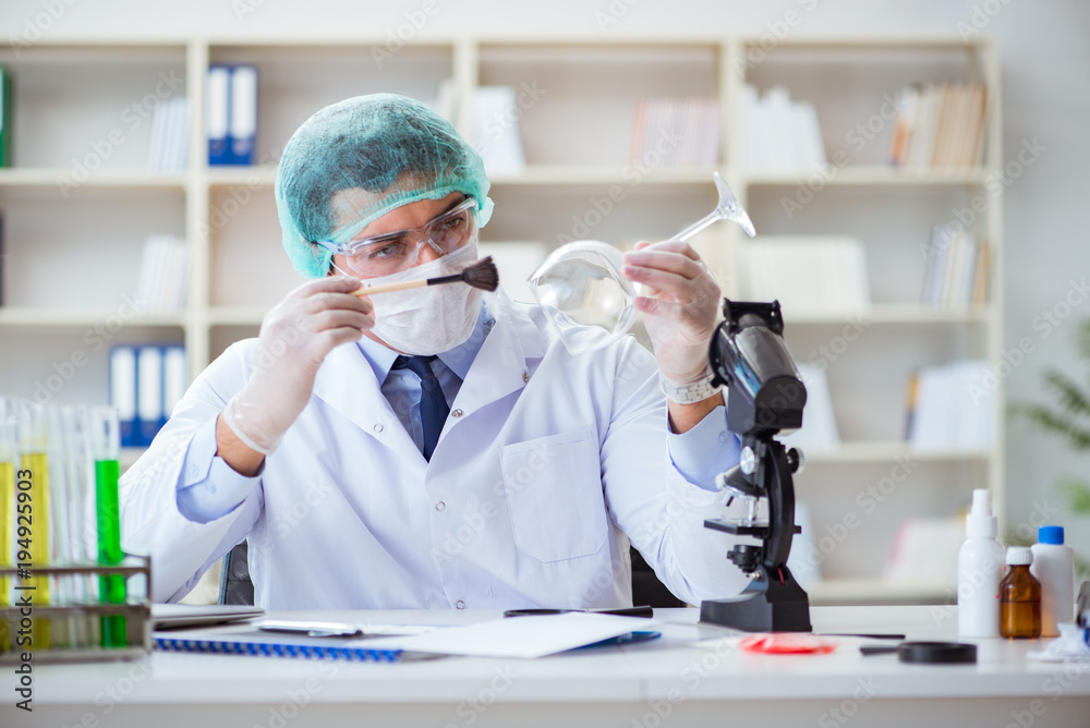 Forensics investigator working in lab on crime evidence Forensics investigator working in lab on crime evidence