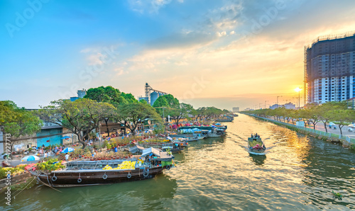 Ho Chi Minh City, Vietnam - February 13, 2018: Boating along canal with apricot carry flowers, confetti, almond tree spring to sell everyone distillation welcome Tet in Ho Chi Minh City, Vietnam