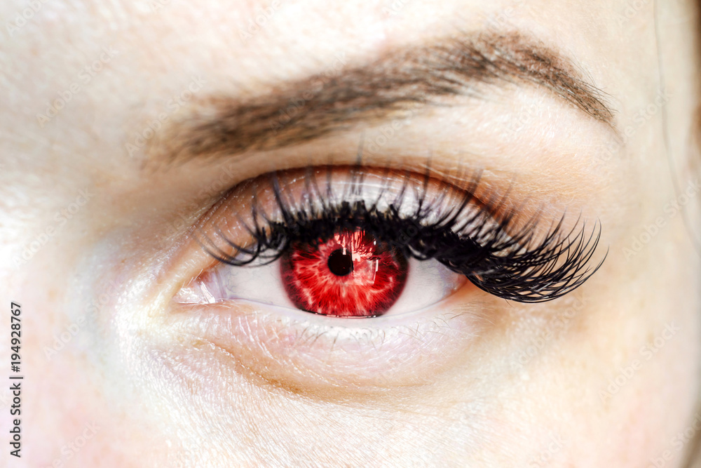 Fototapeta premium female red eye looking at the camera, color contact lenses