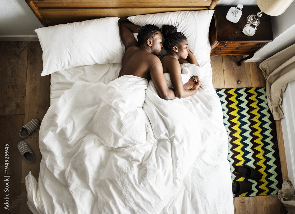 Fotka „African descent couple sleeping on the bed snuggling and hugging“ ze  služby Stock | Adobe Stock