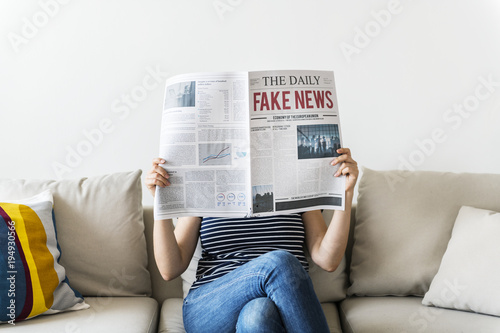 Woman reading newspaper