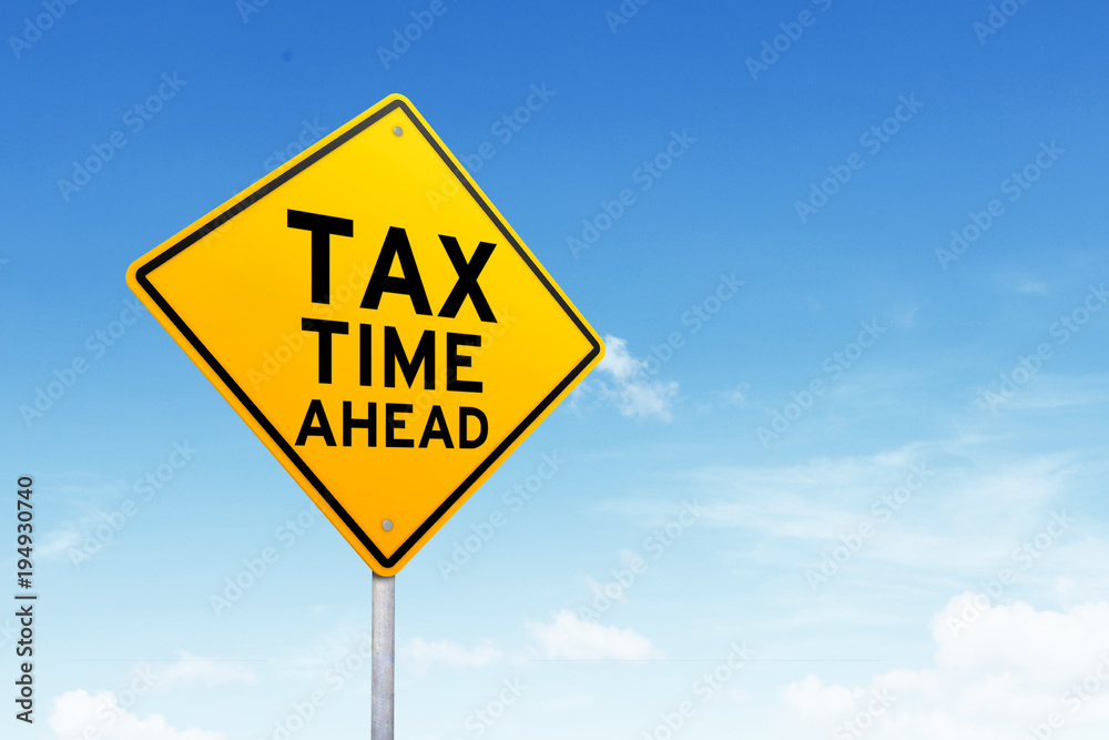 Tax time road sign shot over beautiful blue sky. Tax time road sign shot over beautiful blue sky.
