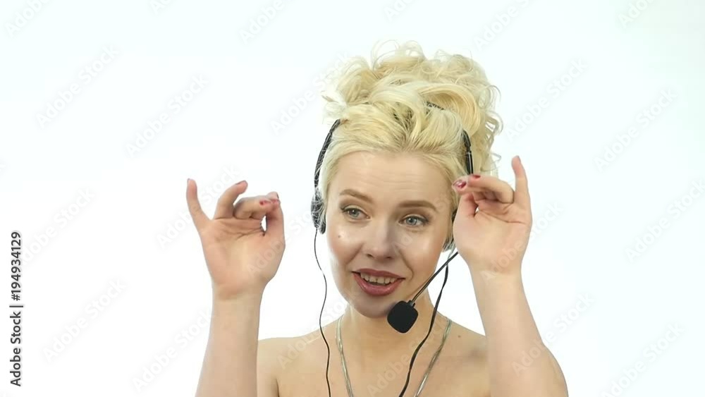 Sexy smiling woman working in a call center. Headset telemarketing woman talking on helpline. slow motion Sexy smiling woman working in a call center. Headset telemarketing woman talking on helpline. slow motion