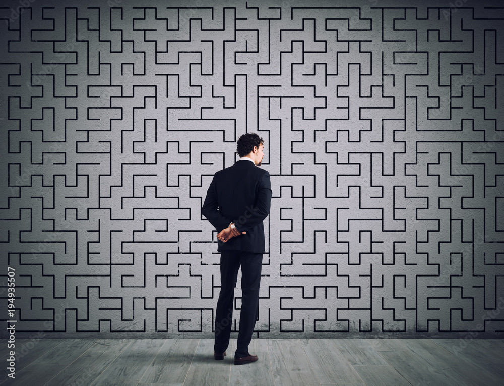 Businessman draws the solution of a labyrinth. Concept of problem solving Businessman draws the solution of a labyrinth. Concept of problem solving
