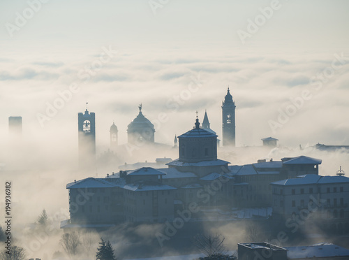 Bergamo  Italy. Drone aerial view of an amazing landscape of the fog rises from the plains and covers the old town