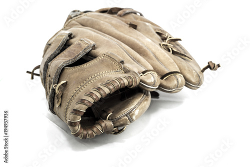 Old worn leather baseball glove on a white background.