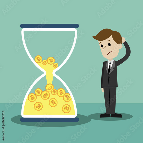 Crypto-currency market. Businessman is standing and seeing sandglass with Bitcoins and loosing its.