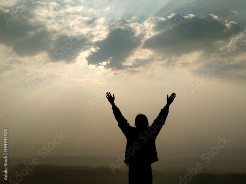Tablou pe pânză A person release all the pain and feel free in the nature, hand up in sky bathin