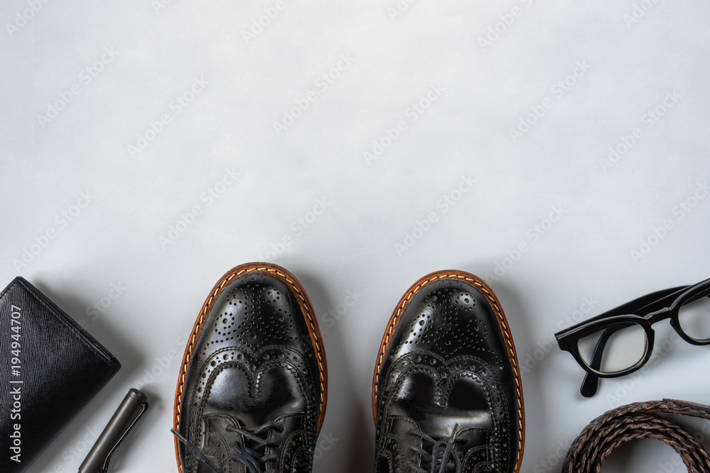 Φωτογραφία Top view of men leather shoes and accesories in black tone, wingtip shoes on gre