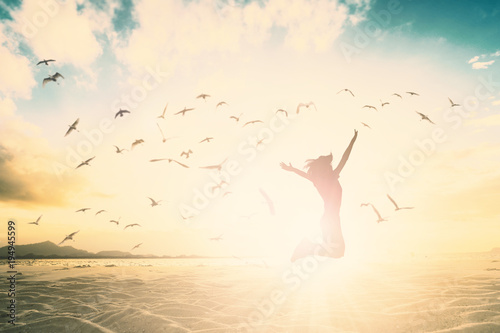 Silhouette woman jump and open arms up on beautiful beach concept for Financial freedom, mission complete, travel in summer high season.