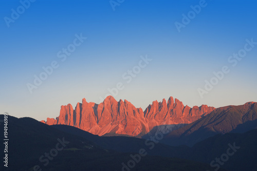 red mountain at sunset. Dolomites landscape in Val di Funes, Italy