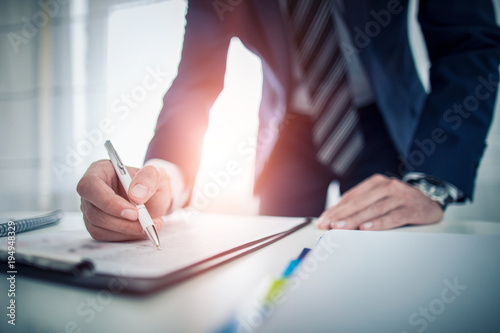 Business man signing contract, making a deal. photo