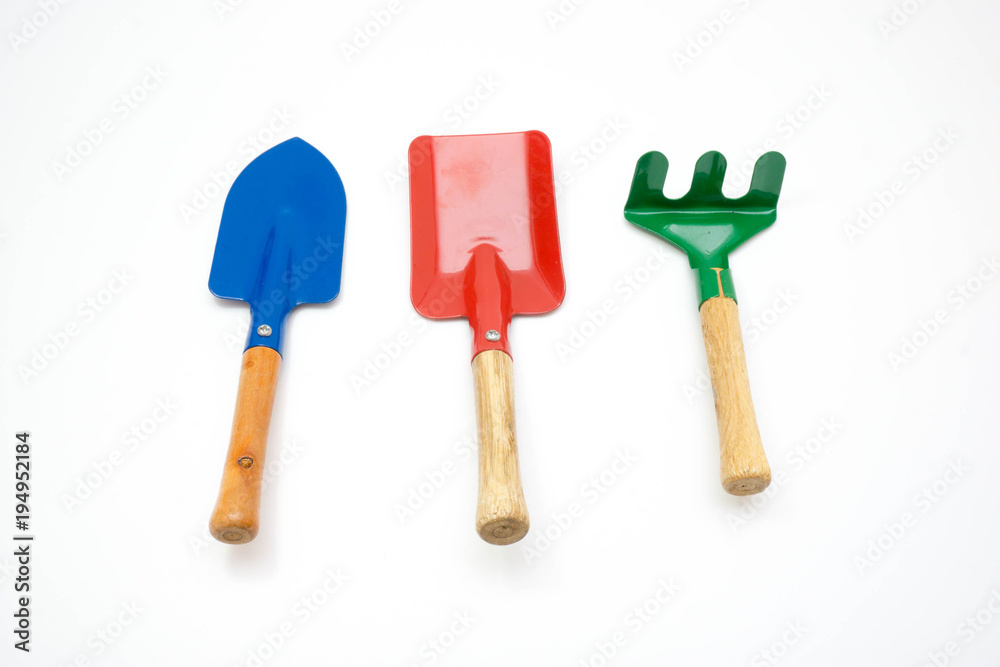 Gardening tools, spade, fork and rake on white background Gardening tools, spade, fork and rake on white background