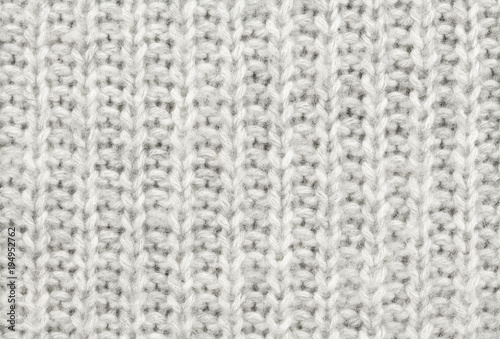 White-gray wool texture. Texture of wool. Knitting natural wool white-gray background.