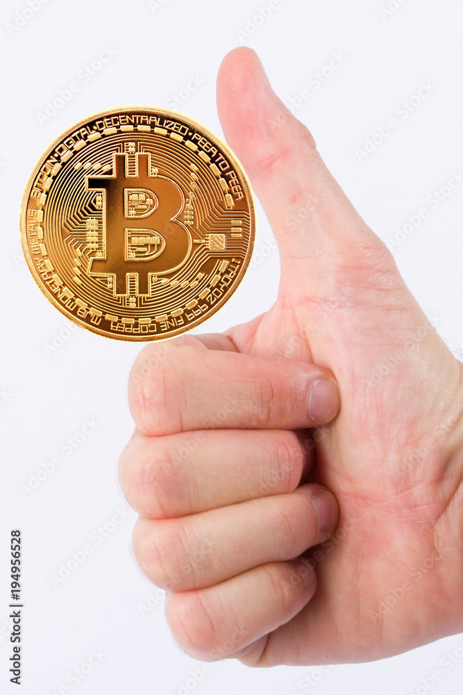 Close up of businessman hand holding virtual bitcoin currency in white background Close up of businessman hand holding virtual bitcoin currency in white background
