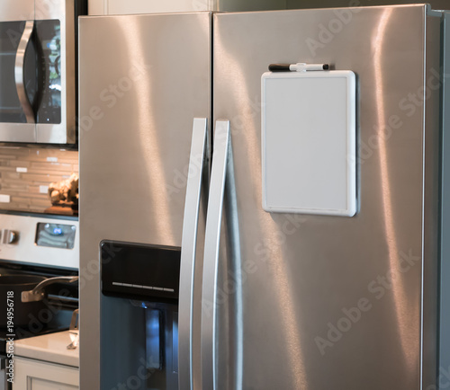 Stainless steel refrigerator with a magnetic dry erase whiteboard