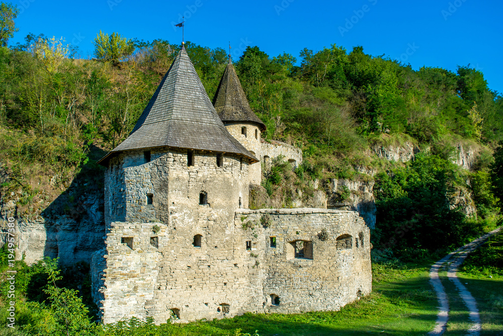 Photo of ancient stone tower of castle in Kamyanets-Podilsky Photo of ancient stone tower of castle in Kamyanets-Podilsky